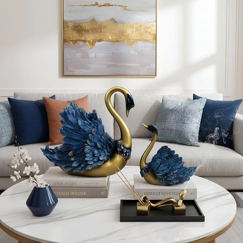 Decorative swan sculptures on a coffee table with a couch and abstract painting in the background