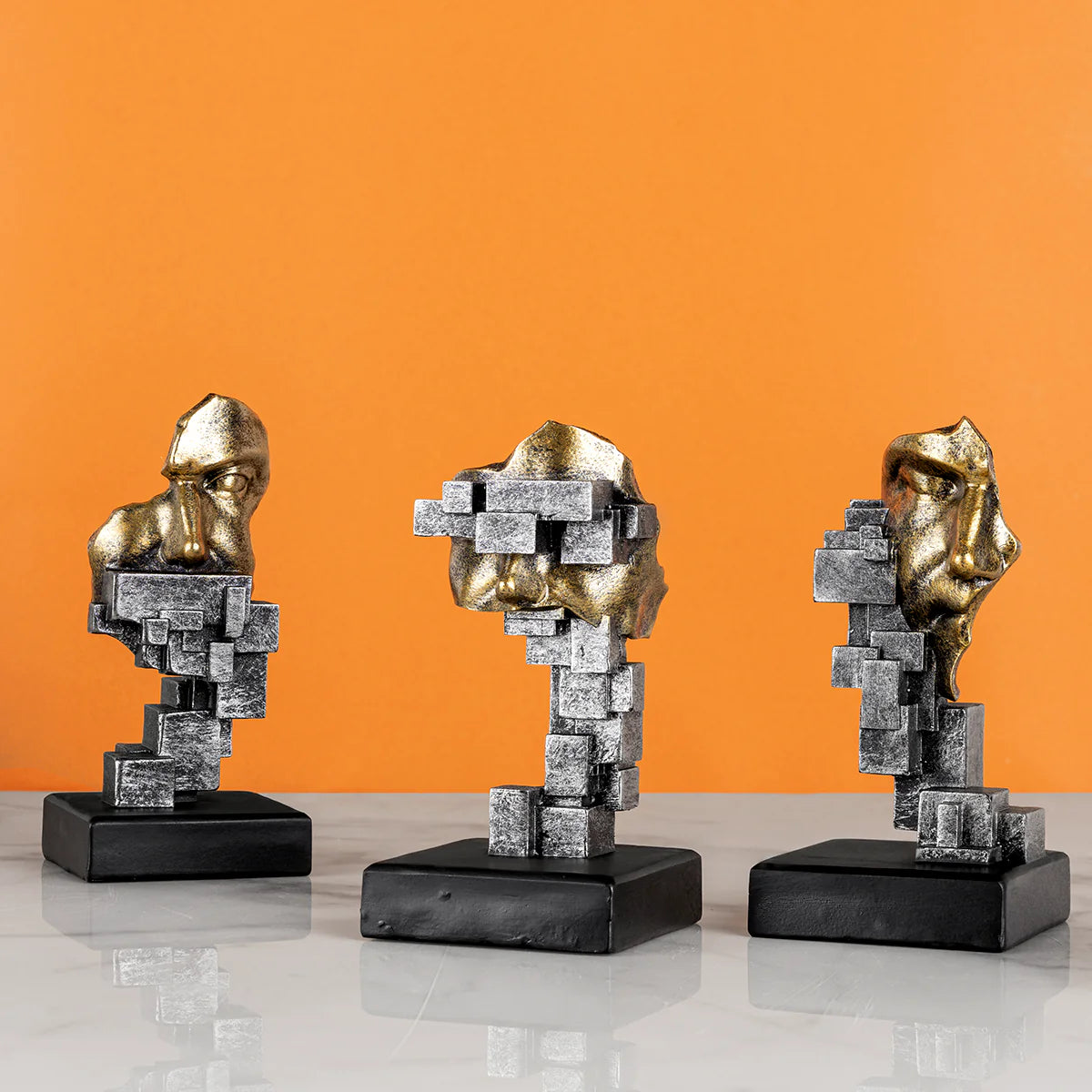 Abstract geometric face sculpture set with metallic detailing for modern tabletop decor