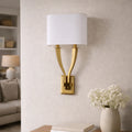 Modern gold wall sconce light with fabric shade for contemporary interiors