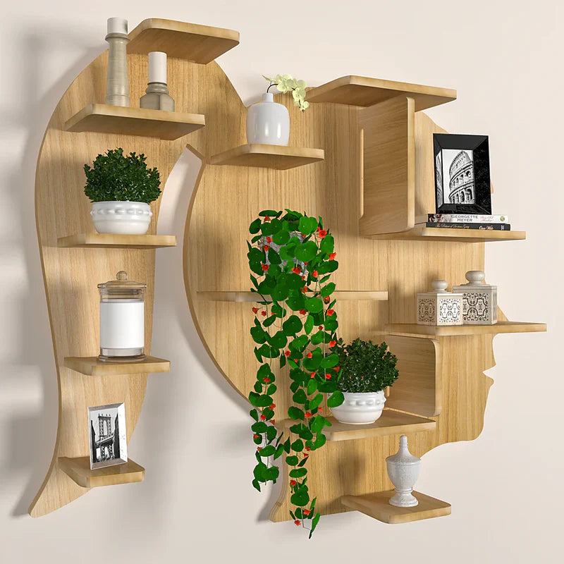 Wooden wall shelf with decorative items including plants and pictures on a plain background